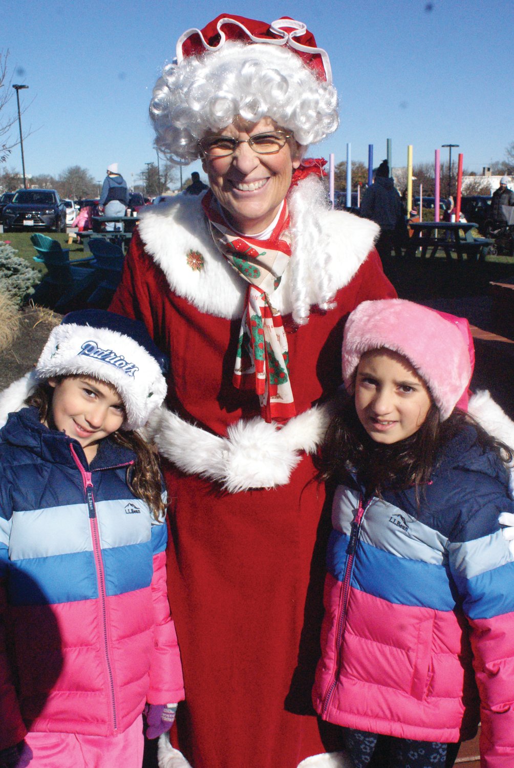 VISITING WITH HER HUSBAND: Mrs. Claus with sisters Gia, 5, and Ella DeLucia, 8.